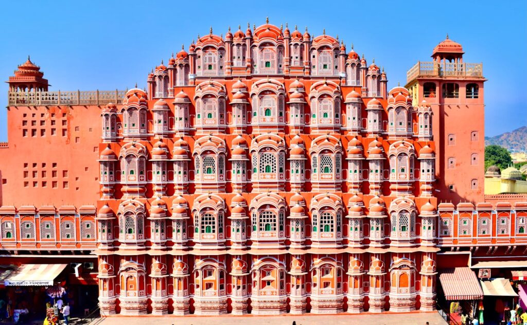Explore the stunning pink sandstone facade of Hawa Mahal in Jaipur, India.