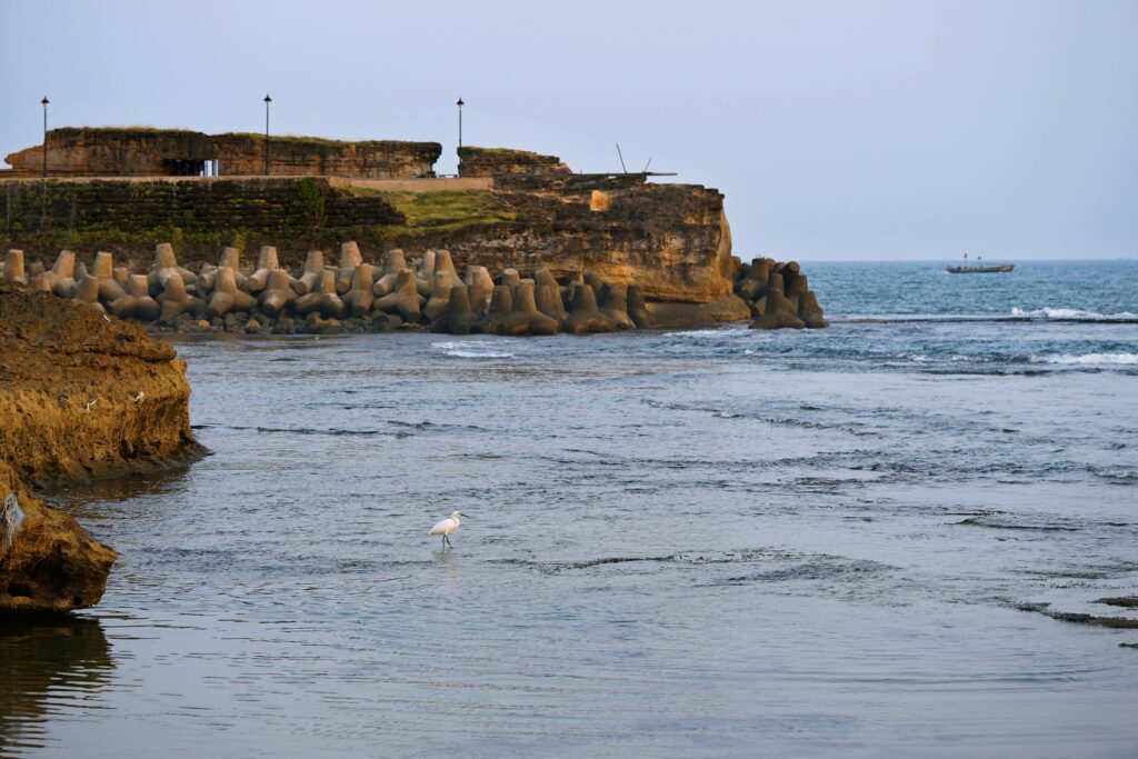Capture of a serene seaside at Diu, India, featuring a historic fort and calm waters.