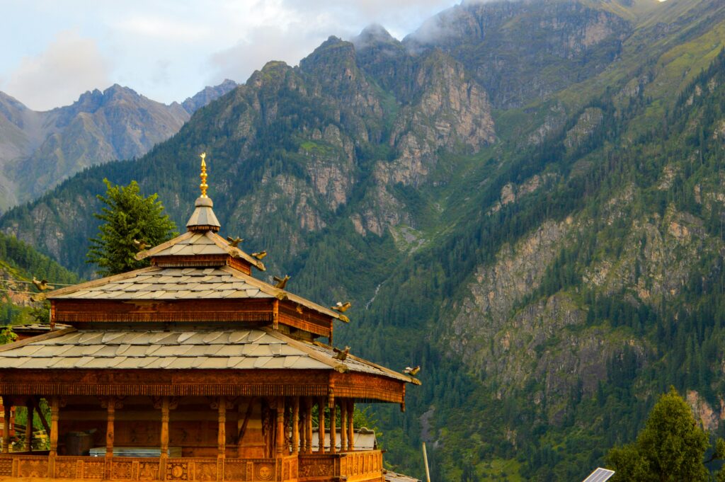 Discover a serene Himachal Pradesh temple set against stunning mountain backdrops, capturing Indian architecture.