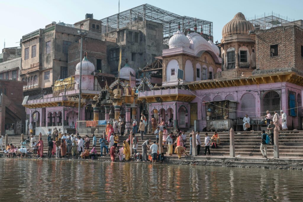 Vibrant community gathering at historical Yamuna river ghats in Mathura, India.
