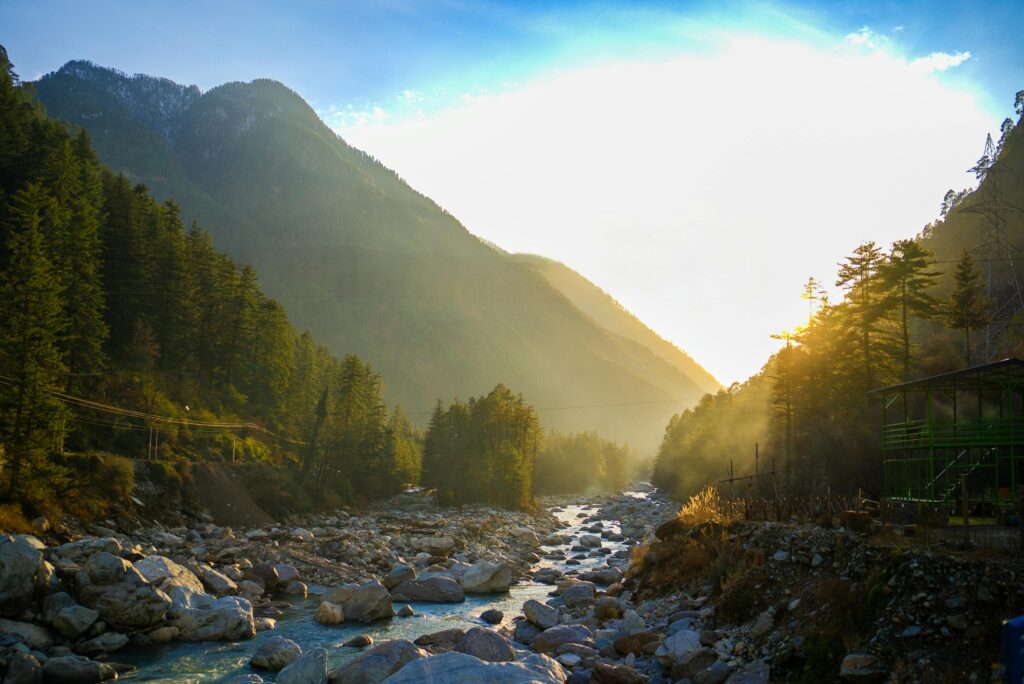 Breathtaking view of sunrise over the river in Kasol, Himachal Pradesh, India, showcasing natural beauty.